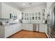 Well-lit kitchen featuring white cabinets, granite countertops, and stainless steel appliances at 104 Glentown Way, Sandy Springs, GA 30328