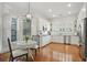 Bright eat-in kitchen featuring white cabinets, stainless steel appliances, and hardwood floors at 104 Glentown Way, Sandy Springs, GA 30328