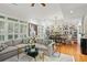 Bright living and dining space with hardwood floors, bookshelves, and comfortable seating at 104 Glentown Way, Sandy Springs, GA 30328