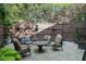 Cozy backyard patio with comfortable seating, a fire pit, and a charming fence adorned with hanging plants at 104 Glentown Way, Sandy Springs, GA 30328