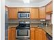 Kitchen with stainless steel appliances, granite countertops, and wood cabinets at 2870 Pharr Court South Nw # 1704, Atlanta, GA 30305