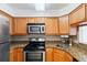Kitchen with stainless steel appliances, granite countertops, and wood cabinets at 2870 Pharr Court South Nw # 1704, Atlanta, GA 30305