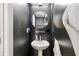 Elegant powder room features pedestal sink, a circular mirror, and an art deco accent wall at 371 Northaven Ave, Suwanee, GA 30024