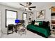 Bright bedroom featuring a ceiling fan, large windows, and a desk with computer setup at 371 Northaven Ave, Suwanee, GA 30024