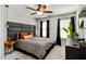 Modern bedroom with a gray bed, black accent wall, and natural light from large windows at 371 Northaven Ave, Suwanee, GA 30024