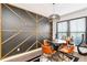 Contemporary dining area with geometric accent wall, unique light fixture, and ample seating at 371 Northaven Ave, Suwanee, GA 30024