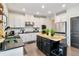 Modern kitchen features white cabinets, black countertops, a gold accented island, and stainless steel appliances at 371 Northaven Ave, Suwanee, GA 30024