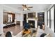 Comfortable living area with fireplace, built-in shelves, and open access to the dining area at 371 Northaven Ave, Suwanee, GA 30024