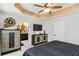 Main bedroom with a tray ceiling flows into an en-suite bathroom with dual sinks and dark cabinets at 371 Northaven Ave, Suwanee, GA 30024