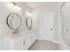 Modern bathroom with dual sinks, white countertops, gold fixtures, and glass shower at 427 Burton Dr, Alpharetta, GA 30009