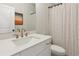 Bathroom with white vanity, gold fixtures, and a patterned shower curtain at 427 Burton Dr, Alpharetta, GA 30009