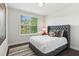 Bedroom with a tufted headboard, white comforter, and large window at 427 Burton Dr, Alpharetta, GA 30009