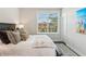 Bedroom with a black headboard bed, accent pillows, and a bright window at 427 Burton Dr, Alpharetta, GA 30009
