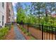 Exterior shot of townhome with a dark fence and landscaping at 427 Burton Dr, Alpharetta, GA 30009