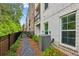 Exterior shot of townhome and lush landscaping, surrounded by fencing at 427 Burton Dr, Alpharetta, GA 30009