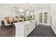 An open-concept kitchen and dining area with stainless appliances, quartz countertops, and views to the living space at 427 Burton Dr, Alpharetta, GA 30009