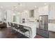 Modern kitchen with a large island, quartz countertops, stainless steel appliances, and designer finishes throughout at 427 Burton Dr, Alpharetta, GA 30009