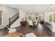 Open-concept living and dining area that includes a kitchen with bar seating and a staircase leading to the second floor at 427 Burton Dr, Alpharetta, GA 30009