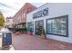 A brick building features a modern storefront, accented by greenery and an inviting atmosphere at 427 Burton Dr, Alpharetta, GA 30009