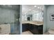 Contemporary bathroom with a glass-enclosed shower, dual sinks, and unique lighting fixtures, providing a modern and stylish experience at 470 Ansley Walk Ne Ter, Atlanta, GA 30309