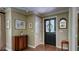 Charming entryway featuring a decorative door, hardwood floors, and a stylish console table at 470 Ansley Walk Ne Ter, Atlanta, GA 30309