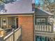 Exterior view of the property featuring a brick facade, covered porch, and a balcony on the second level at 470 Ansley Walk Ne Ter, Atlanta, GA 30309