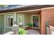 Charming covered entryway with decorative wreath, bench seating, and lush landscaping at 470 Ansley Walk Ne Ter, Atlanta, GA 30309
