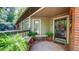 Inviting front porch featuring brick floors and decorative plants at 470 Ansley Walk Ne Ter, Atlanta, GA 30309