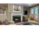 Cozy living room with white fireplace, hardwood floors, and two comfortable armchairs at 470 Ansley Walk Ne Ter, Atlanta, GA 30309