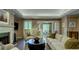 Well-lit living room showcasing a fireplace, plush seating, and seamless access to the outdoors at 470 Ansley Walk Ne Ter, Atlanta, GA 30309