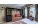 Inviting living room with custom built-ins, sofa, and large windows at 470 Ansley Walk Ne Ter, Atlanta, GA 30309