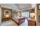 Comfortable bedroom with neutral tones, a ceiling fan, and natural light from a large window at 470 Ansley Walk Ne Ter, Atlanta, GA 30309