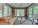 Sun Room with view of the trees, area rug, sofa, and decorative accents at 470 Ansley Walk Ne Ter, Atlanta, GA 30309