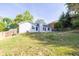 Spacious backyard with lush green grass and a view of the home's exterior at 635 Hickory Nobb, Sugar Hill, GA 30518