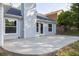 A backyard concrete patio with a view of a light blue house and green foliage at 635 Hickory Nobb, Sugar Hill, GA 30518