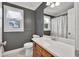 Well-lit bathroom with a white countertop vanity, window with blinds, and a mirror at 635 Hickory Nobb, Sugar Hill, GA 30518