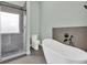 Stylish bathroom featuring a sleek shower, freestanding tub and toilet at 635 Hickory Nobb, Sugar Hill, GA 30518
