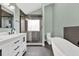 Modern bathroom featuring a soaking tub, tiled shower, and double sink vanity at 635 Hickory Nobb, Sugar Hill, GA 30518
