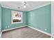 A serene bedroom with a ceiling fan and an outside view through the window at 635 Hickory Nobb, Sugar Hill, GA 30518