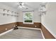 A bedroom with gray flooring, white shelves, and a window view of the street at 635 Hickory Nobb, Sugar Hill, GA 30518
