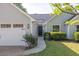 Charming light green home with a two car garage and walkway leading to the front door at 635 Hickory Nobb, Sugar Hill, GA 30518