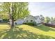 Charming light green home with a well-manicured lawn and mature tree providing shade at 635 Hickory Nobb, Sugar Hill, GA 30518