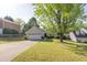 Charming light green home with a two car garage, manicured lawn, and concrete driveway at 635 Hickory Nobb, Sugar Hill, GA 30518