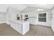 Bright kitchen with white cabinets, quartz countertops, stainless steel appliances, and hardwood flooring at 635 Hickory Nobb, Sugar Hill, GA 30518