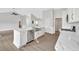 Bright kitchen with white cabinets, quartz countertops, stainless steel appliances, and hardwood flooring at 635 Hickory Nobb, Sugar Hill, GA 30518