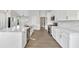 Bright kitchen with white cabinets, quartz countertops, stainless steel appliances, and hardwood flooring at 635 Hickory Nobb, Sugar Hill, GA 30518