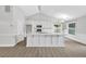 Bright kitchen with white cabinets, quartz countertops, stainless steel appliances, and hardwood flooring at 635 Hickory Nobb, Sugar Hill, GA 30518
