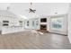 Bright living area boasts a brick fireplace, large windows, and flows seamlessly into the kitchen at 635 Hickory Nobb, Sugar Hill, GA 30518