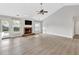 Bright living space features a brick fireplace, large windows, and access to the back yard at 635 Hickory Nobb, Sugar Hill, GA 30518