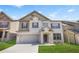 Charming two-story home featuring a brick facade, attached garage, and well-manicured lawn at 7554 Crawford Ct, Fairburn, GA 30213